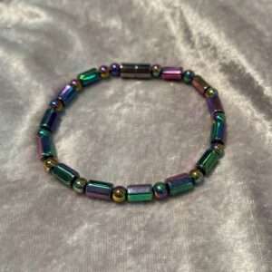 Colorful iridescent beaded bracelet on satin fabric